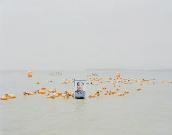 People holding a picture of Mao Zedong across the Yellow River, Henan, 2012
