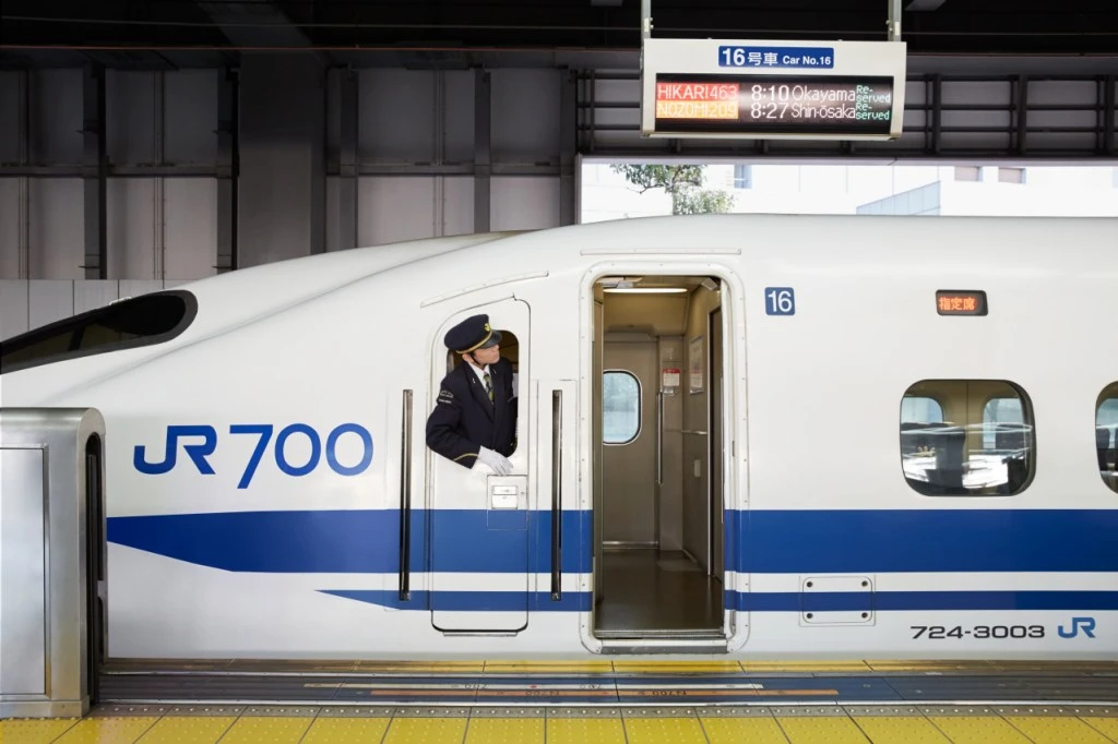 Bullet train driver signalling from window
